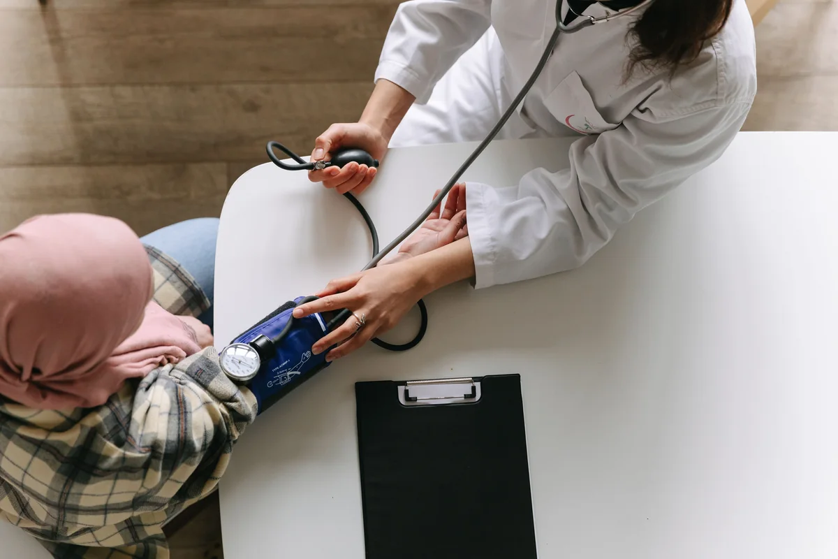 A healthcare professional checking a patient's blood pressure